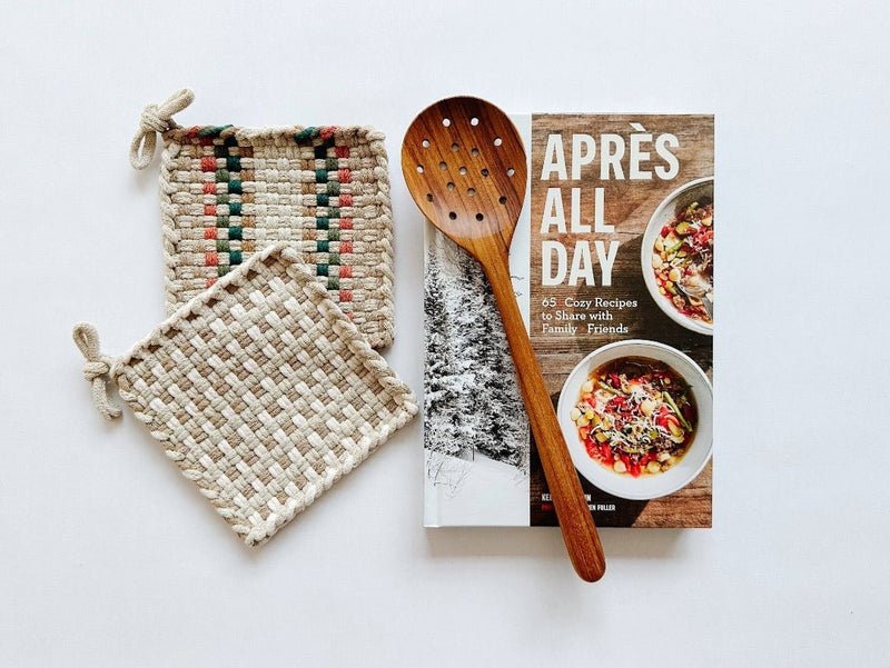 Apres all day cookbook paired with beautiful handwoven potholders and a teak strainer spoon.