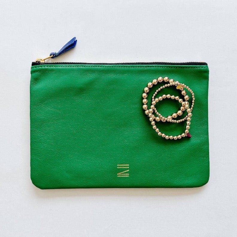 Certain Standard leather pouch in green and beige featured with Shashi bracelets.