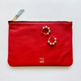 Red leather pouch from Certain Standard featured with Paloma earrings from Shashi.