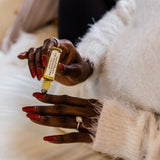 Woman applying the nail and cuticle oil.  