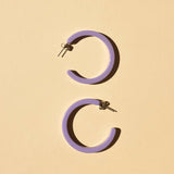 These fun earrings in a fun periwinkle color are the Nat and Noor Nora hoops.