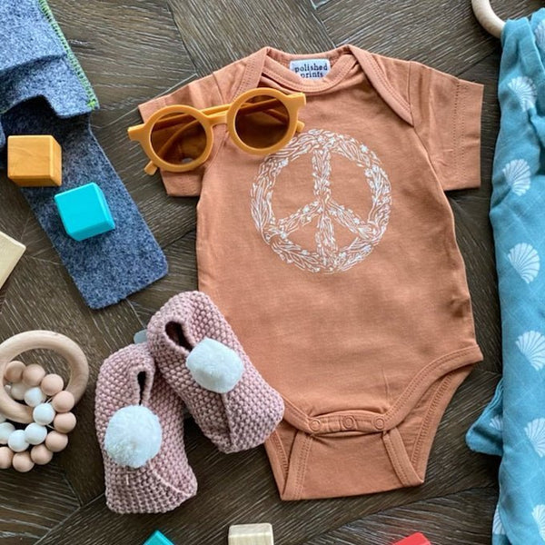 Polished prints peace onesie and sunglasses and alimrose pink baby bootie. Cute gift!