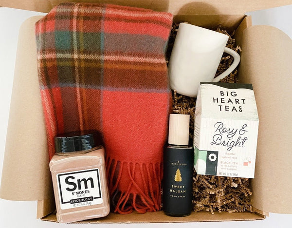 Delight their senses with Tbco. Tartan scarf paired with tea and a mug, smores seasoning, sweet balsam room spray.